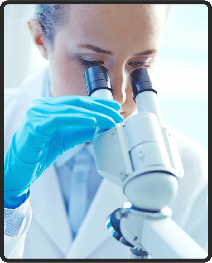 Researcher examining a sample under a microscope